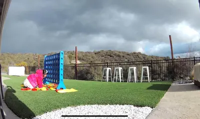 a group of chairs on a field with a playground at Home at Yosemite Oakhurst in Oakhurst