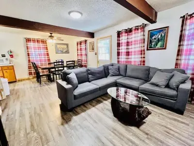 a living room with a couch and a table at Home in Yosemite-Brookside Cottage-Sleeps 10 in Yosemite West