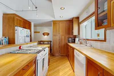 a kitchen with wooden cabinets and a white stove top oven at Mountain View Getaway in Stateline