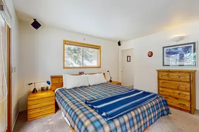 a bedroom with a bed and a dresser and a window at Mountain View Getaway in Stateline