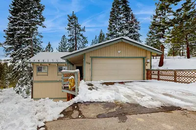 a house with a garage in the snow at Mountain View Getaway in Stateline