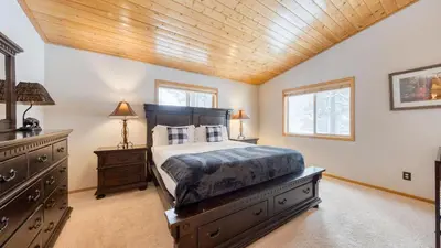 a bedroom with a bed and a wooden ceiling at Oslo Haus by AvantStay Cabin Retreat Near Northstar Downtown Truckee in Truckee