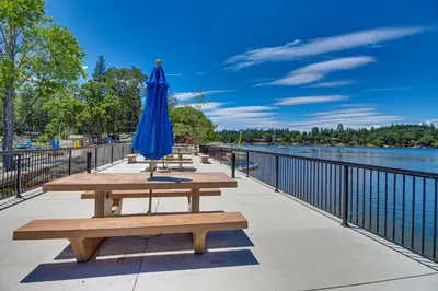 a blue umbrella sitting on a picnic table next to the water at Restoration House in Groveland