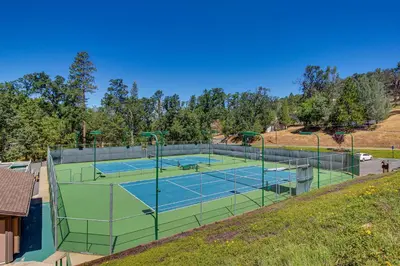 a tennis court on a hill with two courts at Restoration House in Groveland