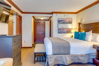 a bedroom with a large bed and a kitchen at Spa and Ski-InandOut Access! Everline Resort Studio in Olympic Valley