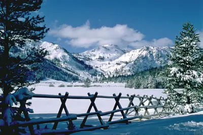 a fence in the snow with mountains in the background at Spa and Ski-InandOut Access! Everline Resort Studio in Olympic Valley