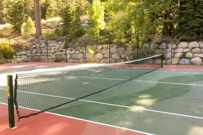 a tennis net on a tennis court at Ski-InandSki-Out and Mtn Views! Everline Resort Condo in Olympic Valley