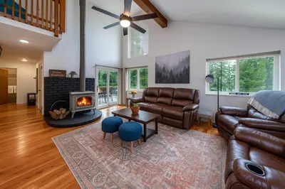 a living room with leather furniture and a fireplace at My Side of the Mountain Rest Recharge Repeat in Shaver Lake