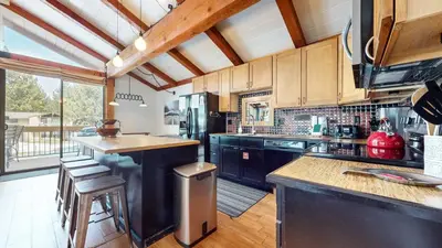 a kitchen with a refrigerator and a counter top at Villa de los Pinos #09 condo in Mammoth Lakes