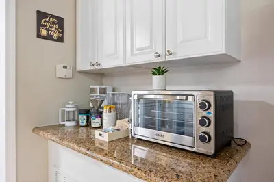 a microwave sitting on a counter in a kitchen at Midtown Apartment with Private Parking and King Bed in Sacramento