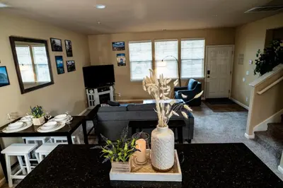 a living room with a couch and a table at Eat-Sleep-Stroll-Repeat! Walkable Midtown 2BR Home in Reno