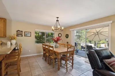 a kitchen and dining room with a table and chairs at Whispering Pines Retreat home in Groveland