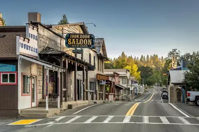 an empty street in a town with a sign for a shop at Whispering Pines Retreat home in Groveland