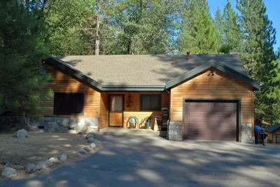 a wooden house with a garage in a driveway at 9N Fox Hollow in Wawona