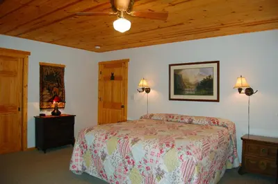 a bedroom with a bed and a ceiling fan at 9N Fox Hollow in Wawona