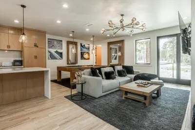 a living room with a couch and a table at New Luxury 4BR /3BA Obsidian Reserve #110 – Hot Tub, 2-Car Garage, Pool Table, Mount Views! in Mammoth Lakes