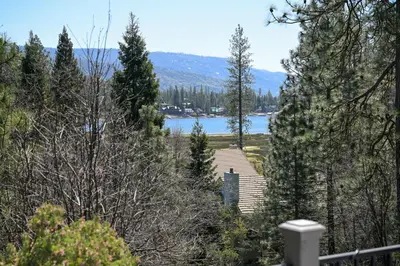 a view of a lake through the trees at Near Yosemite Bass Lake Cabin with Hot Tub, Lake View, Pet Friendly in Bass Lake
