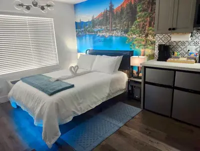 a bedroom with a large bed with a painting on the wall at The Rivet in Reno