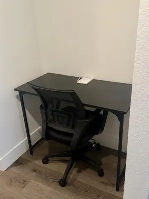 a black desk with a black chair in a room at The Rivet in Reno