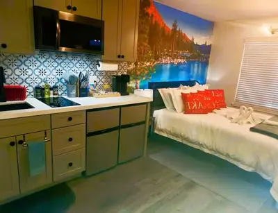 a kitchen with a bed and a sink in a room at The Rivet in Reno