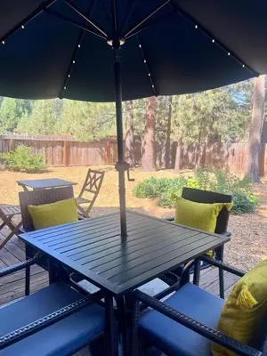 a picnic table with an umbrella on a patio at Emerald Bay Escape in South Lake Tahoe