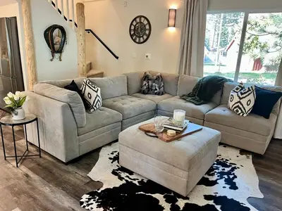 a living room with a couch and a dog sitting on it at Emerald Bay Escape in South Lake Tahoe
