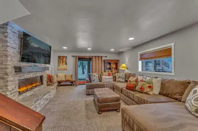 a living room with a couch and a fireplace at The Lazy Bear Northstar Resort Truckee in Truckee