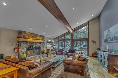 a living room with leather furniture and a fireplace at The Lazy Bear Northstar Resort Truckee in Truckee