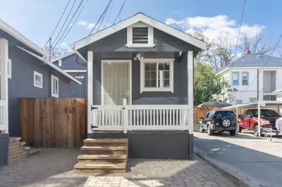 a small black house with a white porch at Modern 1-BR Apartment Close to Downtown Vibes in Reno