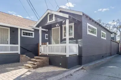 a gray house with a front porch and a porch at Modern 1-BR Apartment Close to Downtown Vibes in Reno
