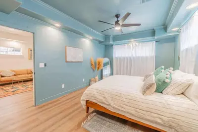 a bedroom with blue walls and a bed with a ceiling fan at Stylish 2-Bedroom walking distance to Downtown in Reno