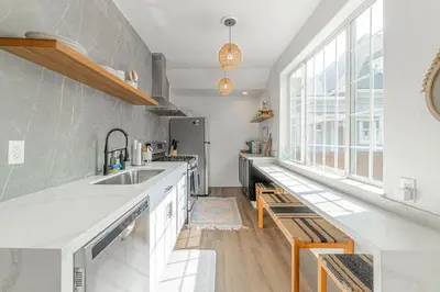 a kitchen with white counters and a large window at Stylish 2-Bedroom walking distance to Downtown in Reno