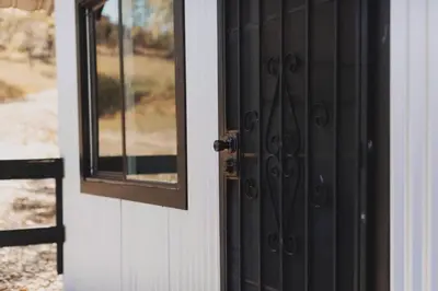 a black door with a window on a house at Secluded rustic 2-bedroom cabin on private land in Miramonte