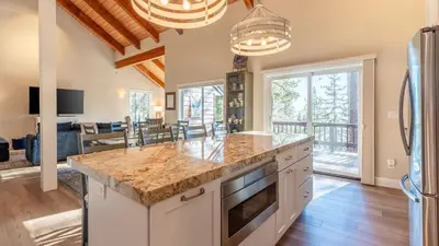 a kitchen with a large counter top and a living room at Views Mins to Skiing Lake Incline Village Incline Serenity by AvantStay in Incline Village