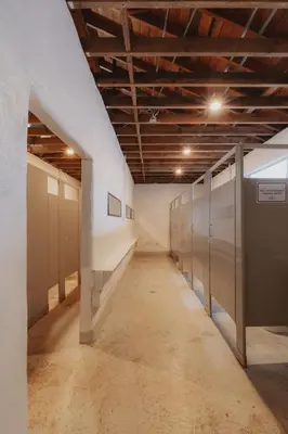 an empty hallway with lockers in a building at Mongolian yurt at a nature retreat in Miramonte