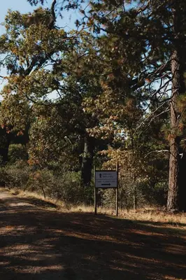 a sign on the side of a road with trees at Cosy yurt at a nature retreat in Sequoia N Forest in Miramonte
