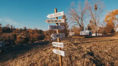 a street sign with arrows pointing in different directions at Glamping yurt at nature retreat in Sequoia NForest in Miramonte