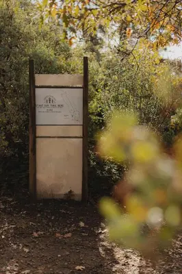 a sign sitting in the middle of a dirt road at Cosy yurt at a nature retreat in CA in Miramonte