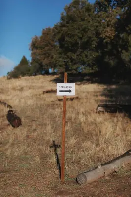 a sign on a wooden pole in a field at Glamping yurt at a nature retreat near Sequoia in Miramonte