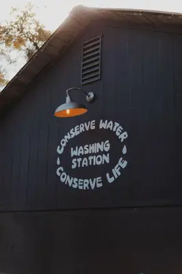 a building with a sign on the side of it at Cosy yurt at a nature retreat in Sequoia Forest in Miramonte