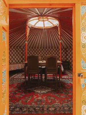 a table and two chairs in a tent at Glamping yurt at a nature retreat Sequoia Highland in Miramonte