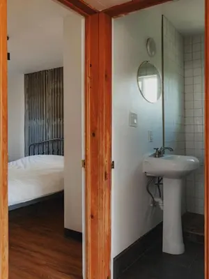 a bathroom with a sink and a bed at Secluded rustic 2-bedroom cabin on nature retreat in Miramonte