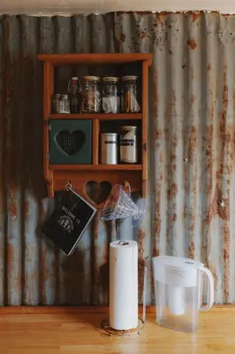 a counter with a shelf with jars on it at Spacious 4-bedroom cabin on secluded private land in Miramonte
