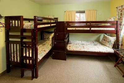 two bunk beds in a room with at Moderne Hostel in Mammoth Lakes