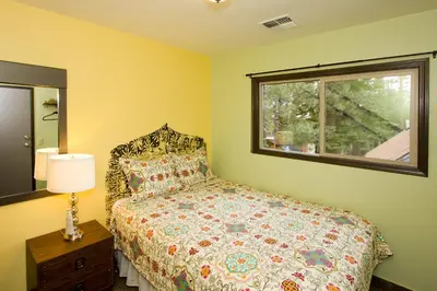 a bedroom with a bed and a window at Moderne Hostel in Mammoth Lakes