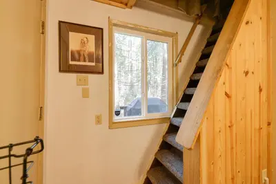 a staircase in a tiny house with a window at Hike, Ski and Sip Arnold Cabin 4 Mi to State Park! in Arnold