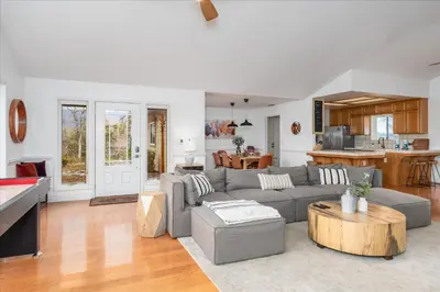 a living room with a gray couch and a table at New Big Sky Cabin at Yosemite w/ VIEWS, hot tub, firepit, and more in Oakhurst