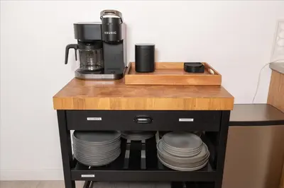 a table with a coffee maker and plates on it at New Yosemite Dream Nest with HUGE views/spa/firepit/pet friendly in Oakhurst