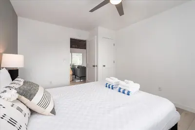 a white bedroom with a bed with towels on it at New Yosemite Dream Nest with HUGE views/spa/firepit/pet friendly in Oakhurst