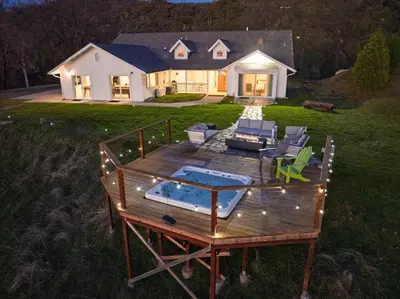 a large deck with chairs and a house at New Yosemite Dream Nest with HUGE views/spa/firepit/pet friendly in Oakhurst